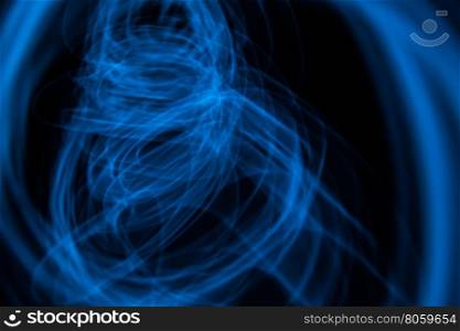 Glowing abstract curved lines.Blue colors.Black background.Done by long exposure technique.