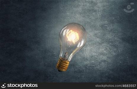 Glowing bulb. Glowing glass light bulb on dark background