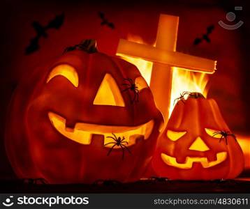 Glowing carved gourd in the hell, burning fire, creepy cross on grave, terrible flying bat, misterious holiday celebration, Halloween party concept
