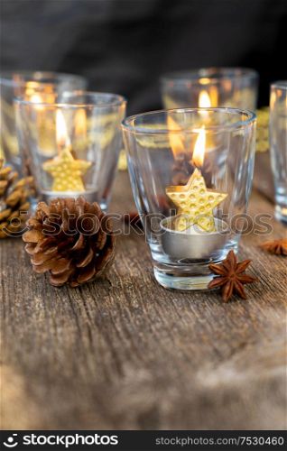 Glowing Christmas candles in glasses. Happy Christas and holidays concept.. Glowing Christmas candles