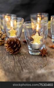 Glowing Christmas candles in glasses. Happy Christas and holidays concept.. Glowing Christmas candles