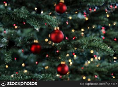 Glowing Christmas tree decorated with red ball ornaments