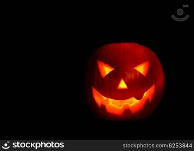 Glowing Halloween pumpkin isolated on black