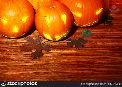 Glowing Halloween pumpkins border, warm candle light, autumn holiday background, traditional jack-o-lantern over wood, night party decoration