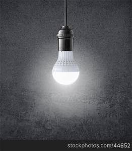 Glowing LED bulb on grunge wall