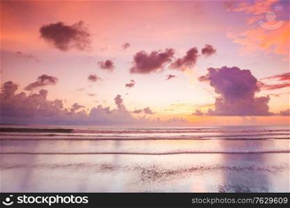 Glowing pink majestic sunset over tropical sea, beautiful natural background. Pink sunset over sea