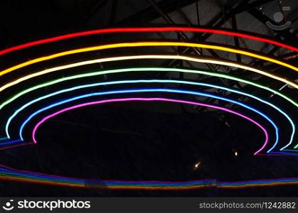 Glowing rainbow lines background . Concept music , disco
