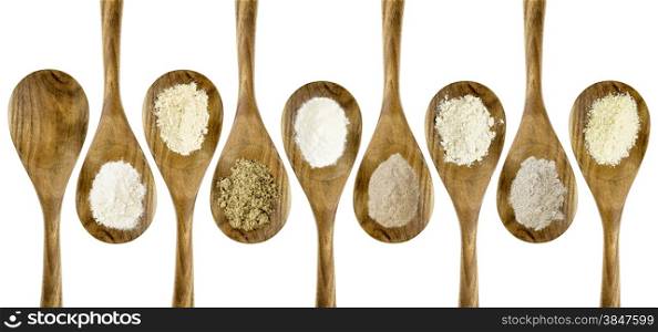 gluten free flours set (almond, coconut, flax meal, brown rice, quinoa, teff, potato, buckwheat) - top view of isolated wooden spoons