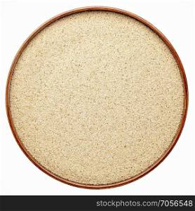 gluten free ivory teff grain in a round wooden tray isolated on white