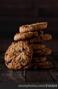 Gluten free oatmeal chocolate cookies with rasins on a old wooden background