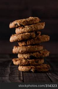 Gluten free oatmeal chocolate cookies with rasins on a old wooden background
