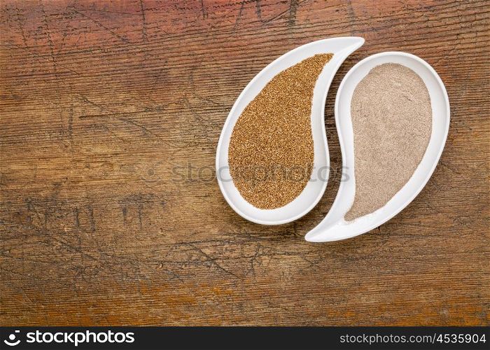 gluten free teff grain and flour in teardrop shaped bowls against grunge wood