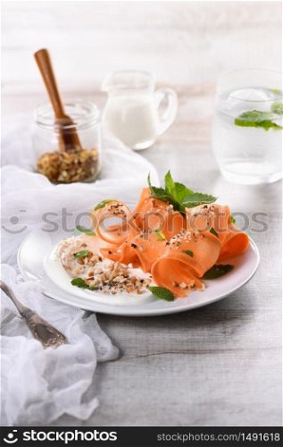 Gluten free vegetarian salad with carrot and yogurt seasoned with crushed nuts and spices, mint castings