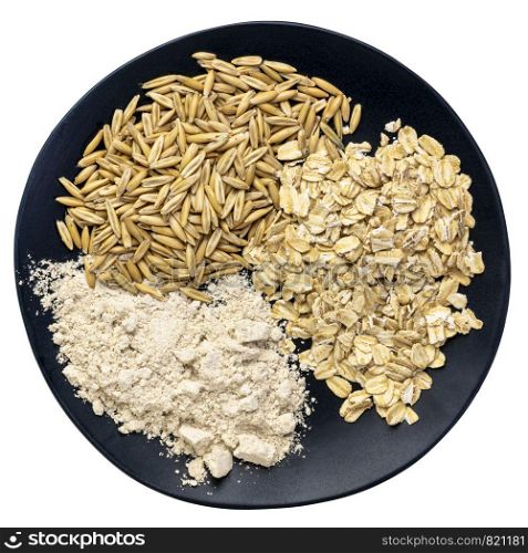 gluten free whole, organic oat groats, flakes and flour - top view of an isolated black plate