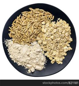 gluten free whole, organic oat groats, flakes and flour - top view of an isolated black plate