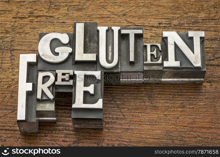 gluten free words in vintage metal type printing blocks over grunge wood - nutrition concept