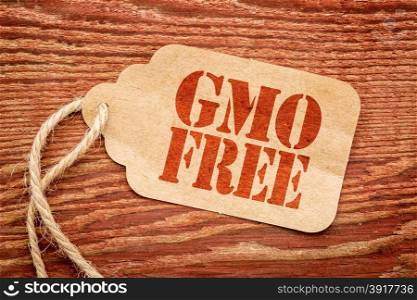 GMO free sign - a paper price tag against rustic red painted barn wood