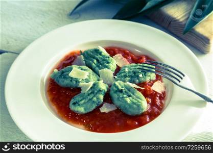 Gnocchi with wild garlic in tomato sauce and parmesan cheese.. Gnocchi with wild garlic in tomato sauce and parmesan cheese