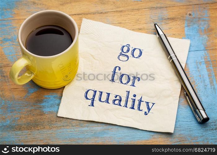 Go for quality advice or reminder - handwriting on a napkin with a cup of espresso coffee