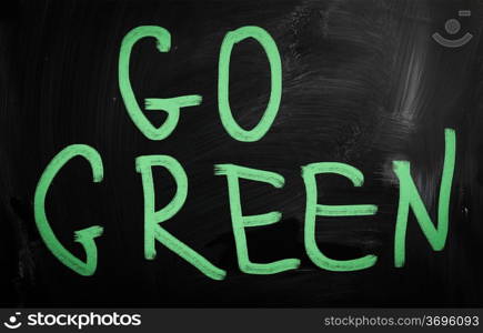 ""Go green" handwritten with white chalk on a blackboard"