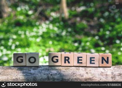 Go green message in a forest at springtime