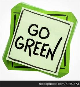 go green reminder - handwriting on an isolated sticky note