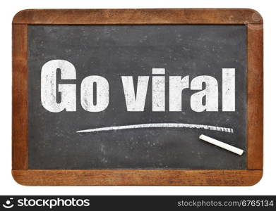 Go viral -white chalk text on a vintage slate blackboard