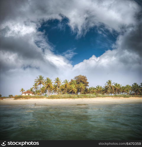 Goa beach with palm trees and clouds in the shape of heart. Goa beach with palm trees