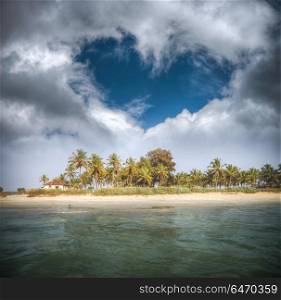 Goa beach with palm trees and clouds in the shape of heart. Goa beach with palm trees