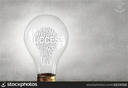 Goal and motivation. Single glass light bulb with business keywords inside