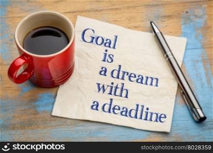 goal is a dream with deadline - handwriting on a napkin with a cup of espresso coffee