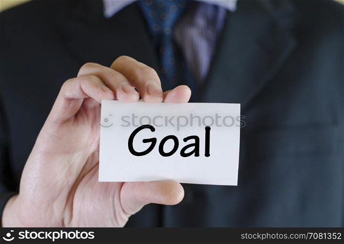Goal text note concept over business man background