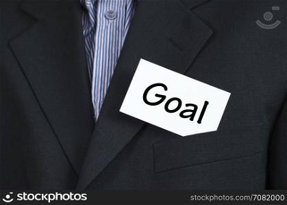 Goal text note concept over business man background