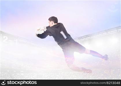 goalkeeper is catching ball. double exposure photo of stadium and soccer or football goalkeeper is catching ball