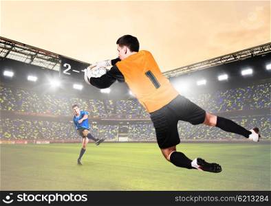 goalkeeper is catching ball. soccer or football goalkeeper is catching ball on stadium