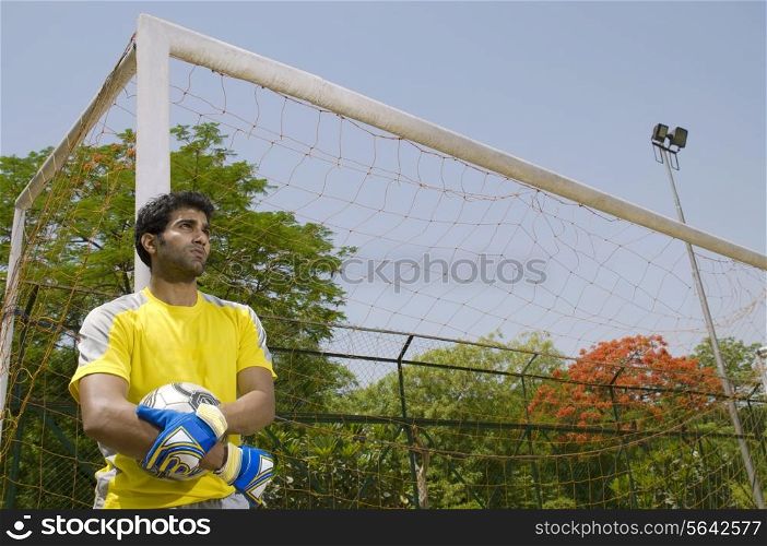 Goalkeeper stands next to the goal post