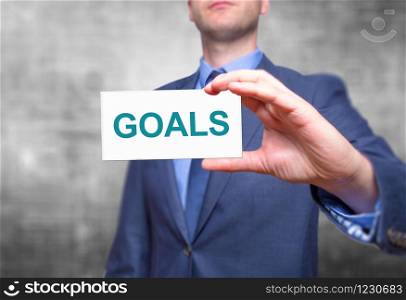 Goals text with businessman holding a sign. Business concept. Stock Photo