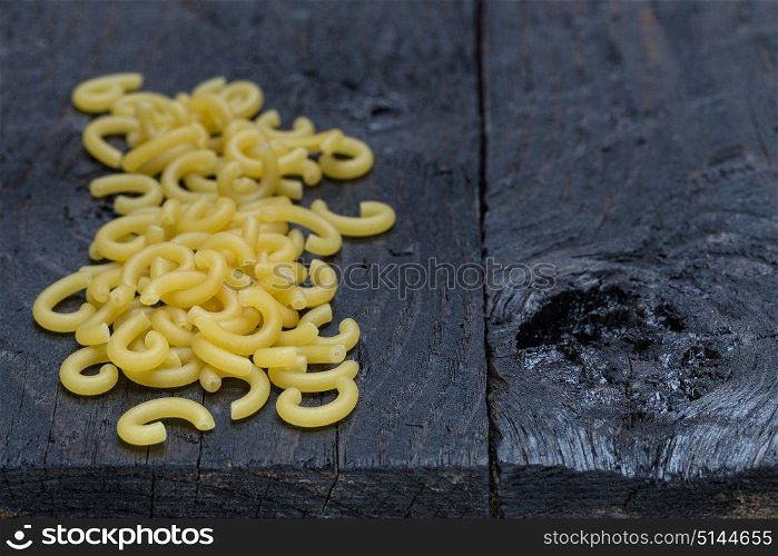 Gobbetti noodles on dark rustic wood.. Gobbetti noodles on dark rustic wood