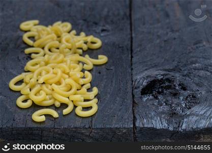 Gobbetti noodles on dark rustic wood.. Gobbetti noodles on dark rustic wood