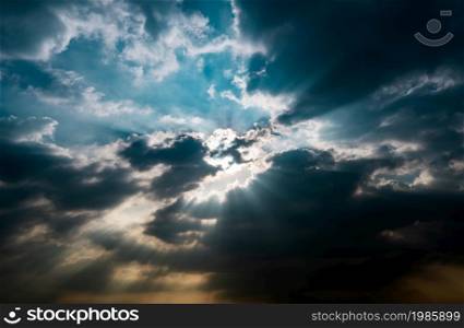 God light. Dark cloudy sky with sun beam. Sun rays through black clouds. God light from heaven for hope and faithful concept. Believe in god. Heaven sky. Overcast sky. Spiritual religious background.