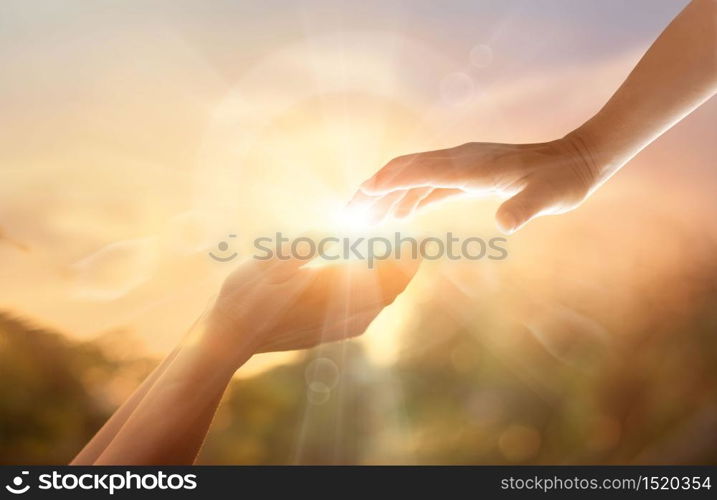 God?s helping hand with the white cross on sunset background. Day of remembrance and good friday concept