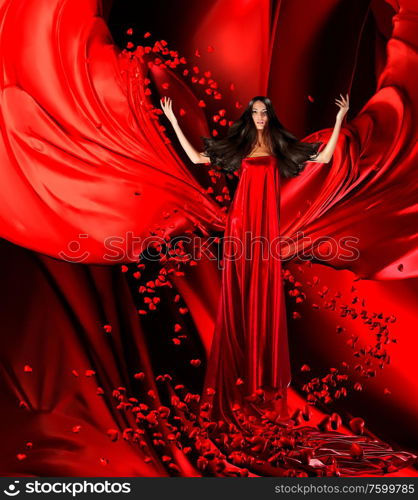 goddess of love in long red dress with magnificent hair makes a magic ritual of connecting hearts of people on red drapery, fabric