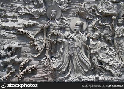 Godness Guan Yin and king on the wall of temple in Putoshan island, China