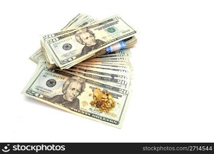Gold And Money. A stack of American twenty dollar bills with an ounce of raw gold nuggets on top