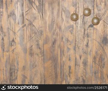 gold and shiny Christmas balls hanging on wooden background. christmas decorations. christmas decorations on wooden background