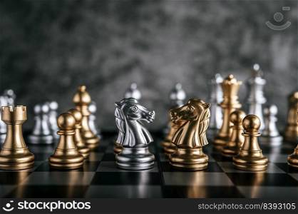 Gold and Silver Chess on chess board game for business metaphor leadership concept 