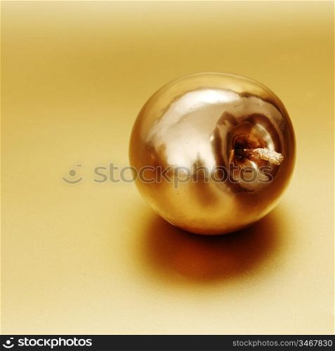 gold apple on gold background