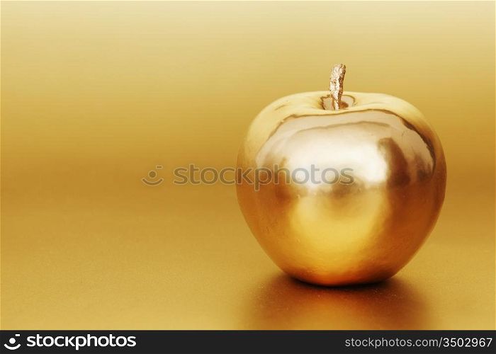 gold apple on gold background