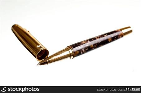 Gold ball point pen and case diagonal on isolated background