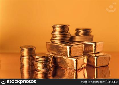 Gold bars and stack of gold coins macro. Rows of coins and gold ingots for finance and banking concept. Economy trends background for business idea. Trade in precious metals. Close up,Selective focus.. Gold bars and stack of gold coins. Background for finance banking concept. Trade in precious metals.